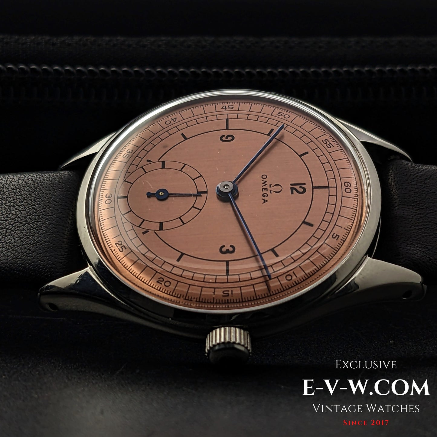 Front view of Omega Vintage 1952 Jumbo Ref. 2505 wristwatch with salmon sector dial, steel case, and black leather strap.