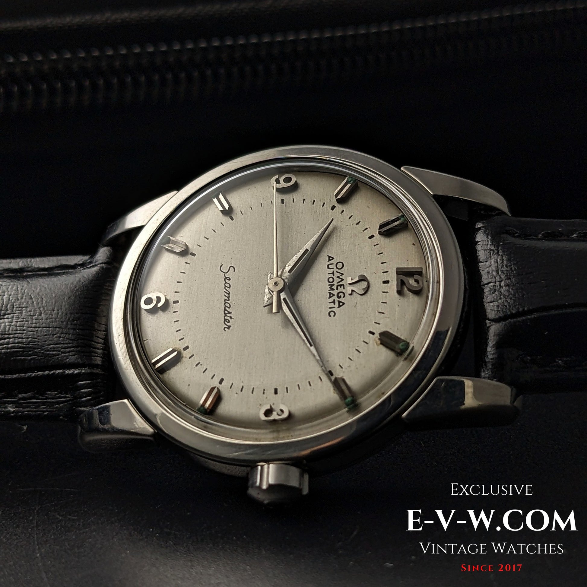 Side view of Vintage 1958 Omega Seamaster Automatic Watch showcasing domed crystal and vintage Omega logo crown.