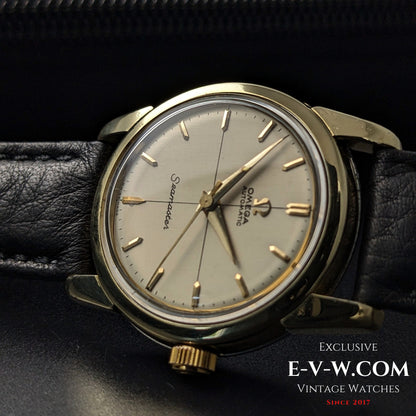 67-Year-Old Omega Seamaster Ref. 2828-9SC Cal. 471 with gold-tone case, cream dial, and black leather strap, displayed on a watch box.