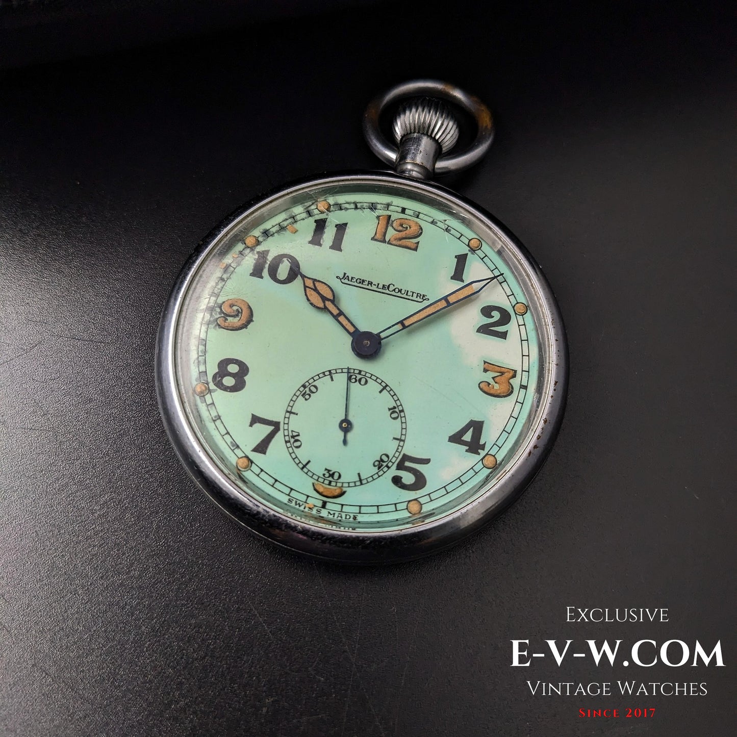 Jaeger-LeCoultre WWII Military Watch Cal. 467 Vintage 1940 resting on black surface, highlighting its mint green dial and steel case.