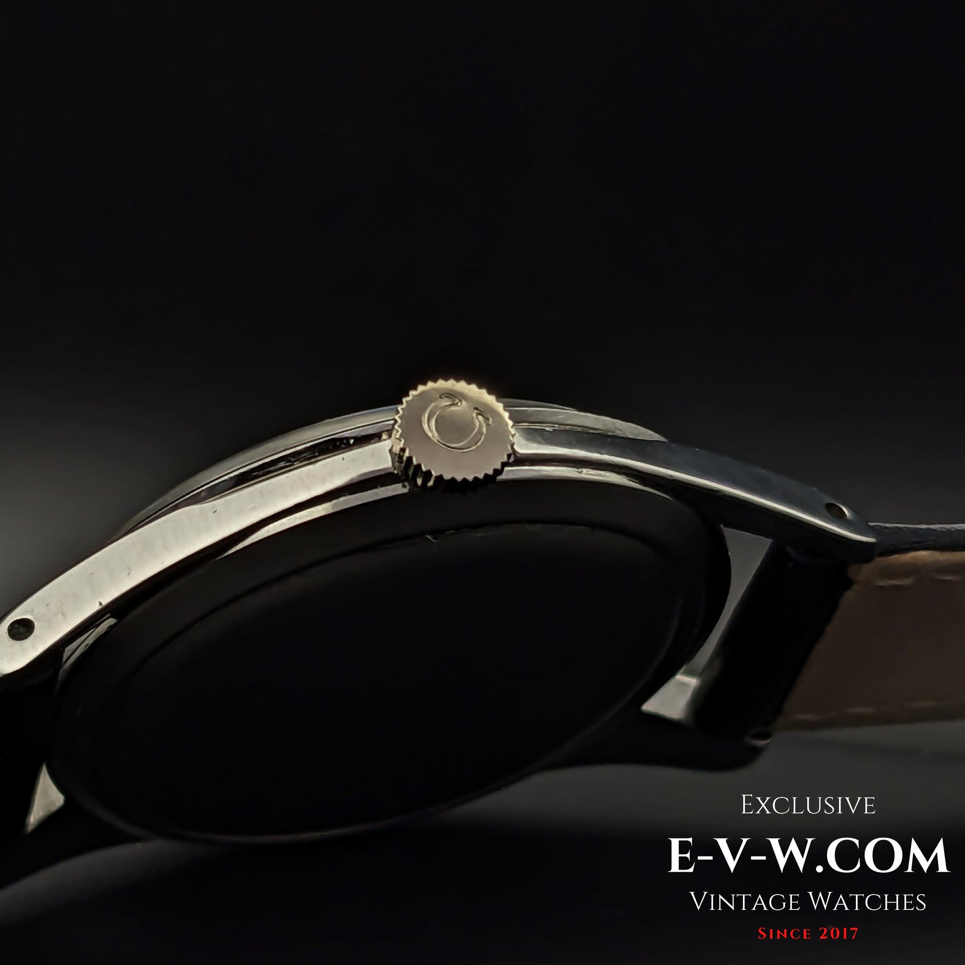 Close-up of the Omega-signed crown on the vintage Ref. 2750-6 wristwatch. A 1954 Swiss-made timepiece with a manual-wind movement.