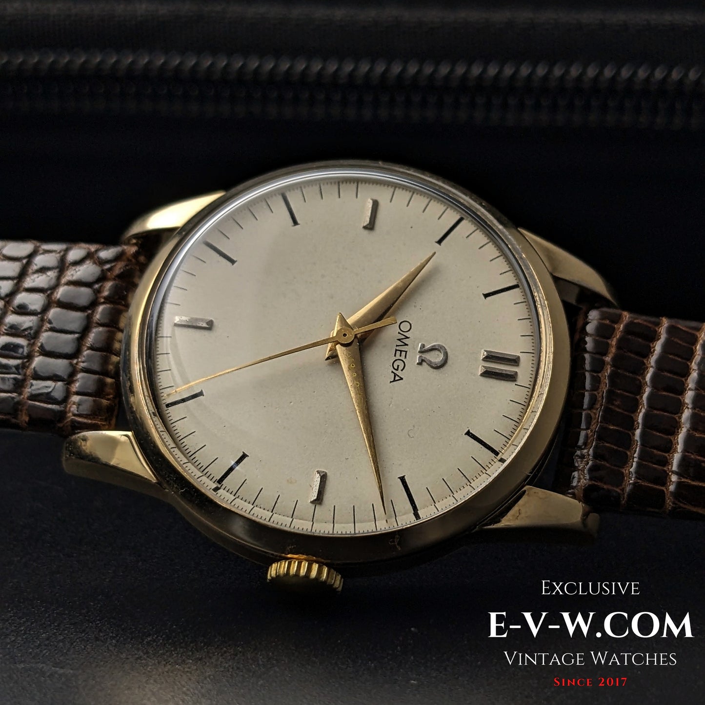 Omega Classic Gold Plaque watch with a vintage cream dial, gold hands, and a brown leather strap, a collector's piece from 1952.