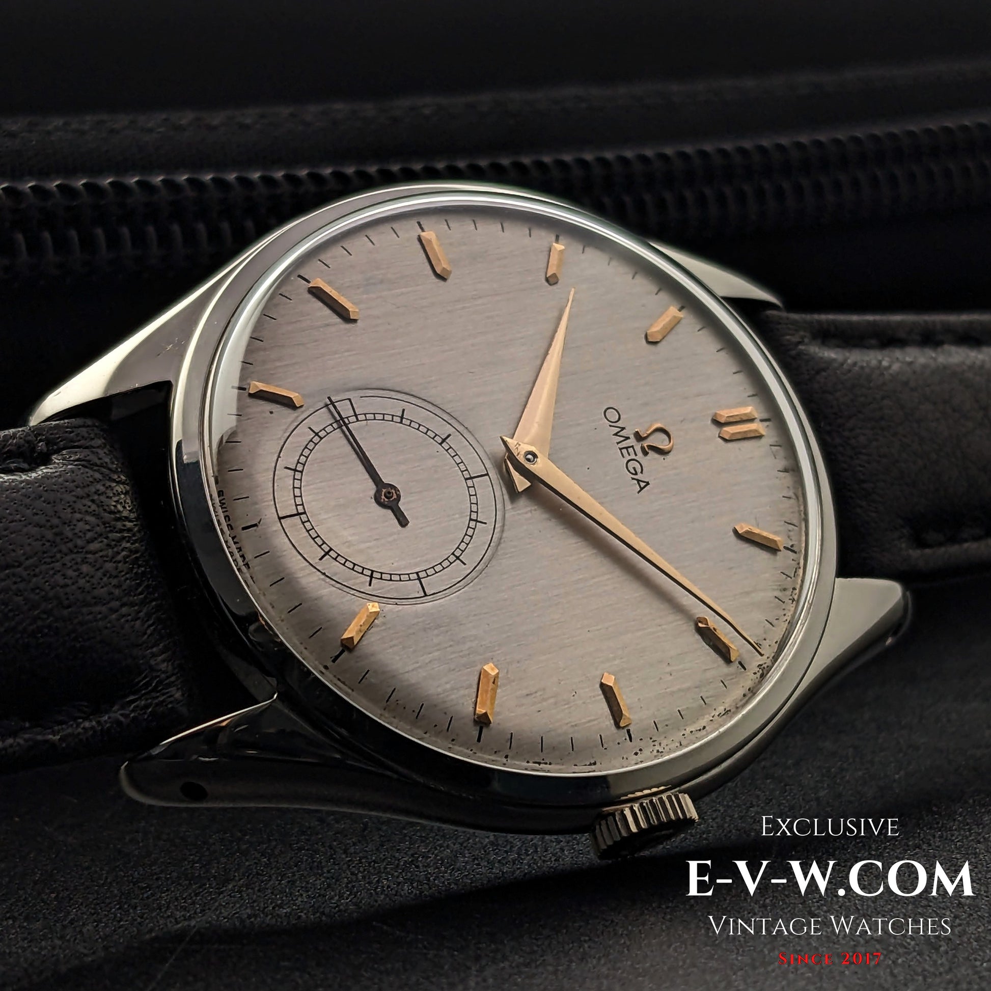 Angled view of Omega Jumbo 38mm Ref. 2505 20 wristwatch, highlighting its vintage silver dial, gold-tone hands, and elegant black leather strap.