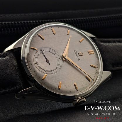 Angled view of Omega Jumbo 38mm Ref. 2505 20 wristwatch, highlighting its vintage silver dial, gold-tone hands, and elegant black leather strap.