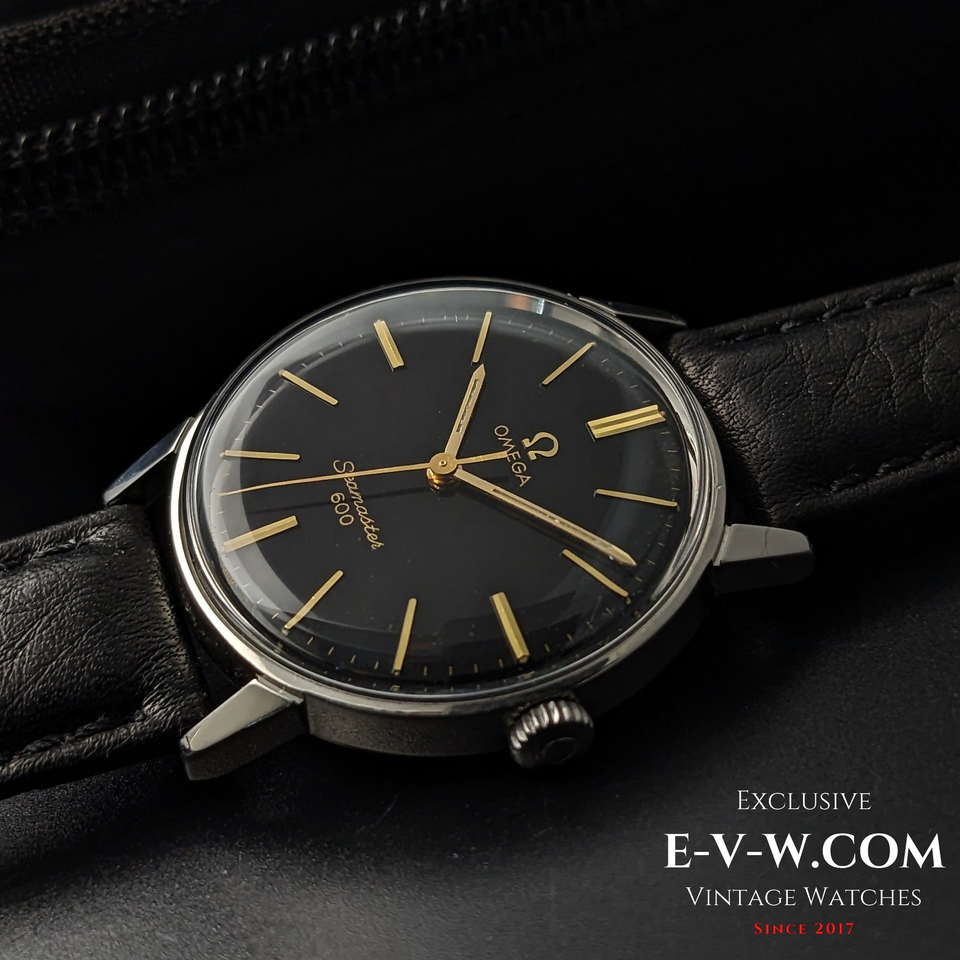 Omega Seamaster 600 1966 Ref. 135011 displayed at an angle, showing black dial, gold hands, and vintage case design on leather strap.