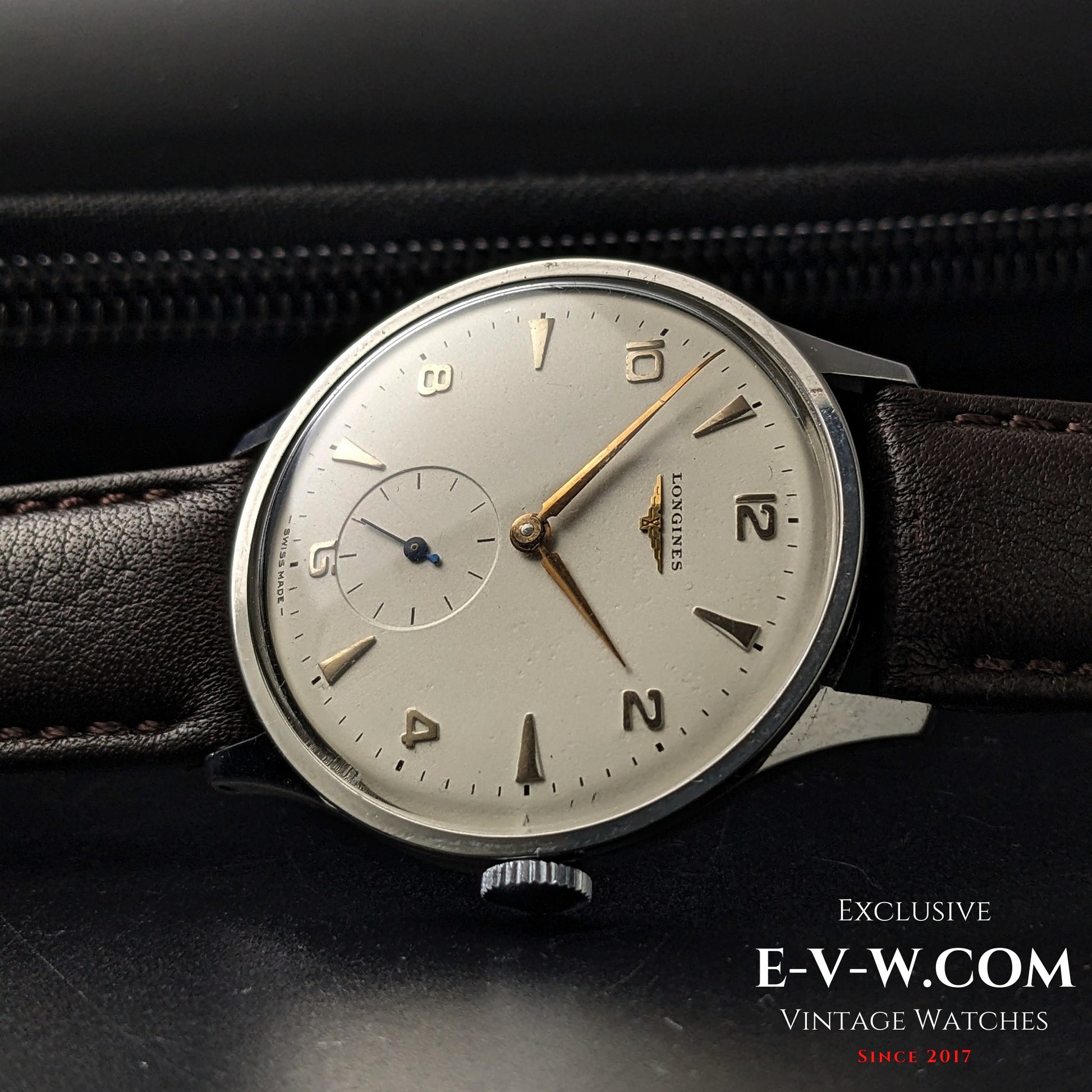 1955 Longines Jumbo Calatrava Ref 2849 displayed on leather case, featuring clean silver dial and vintage Swiss styling.