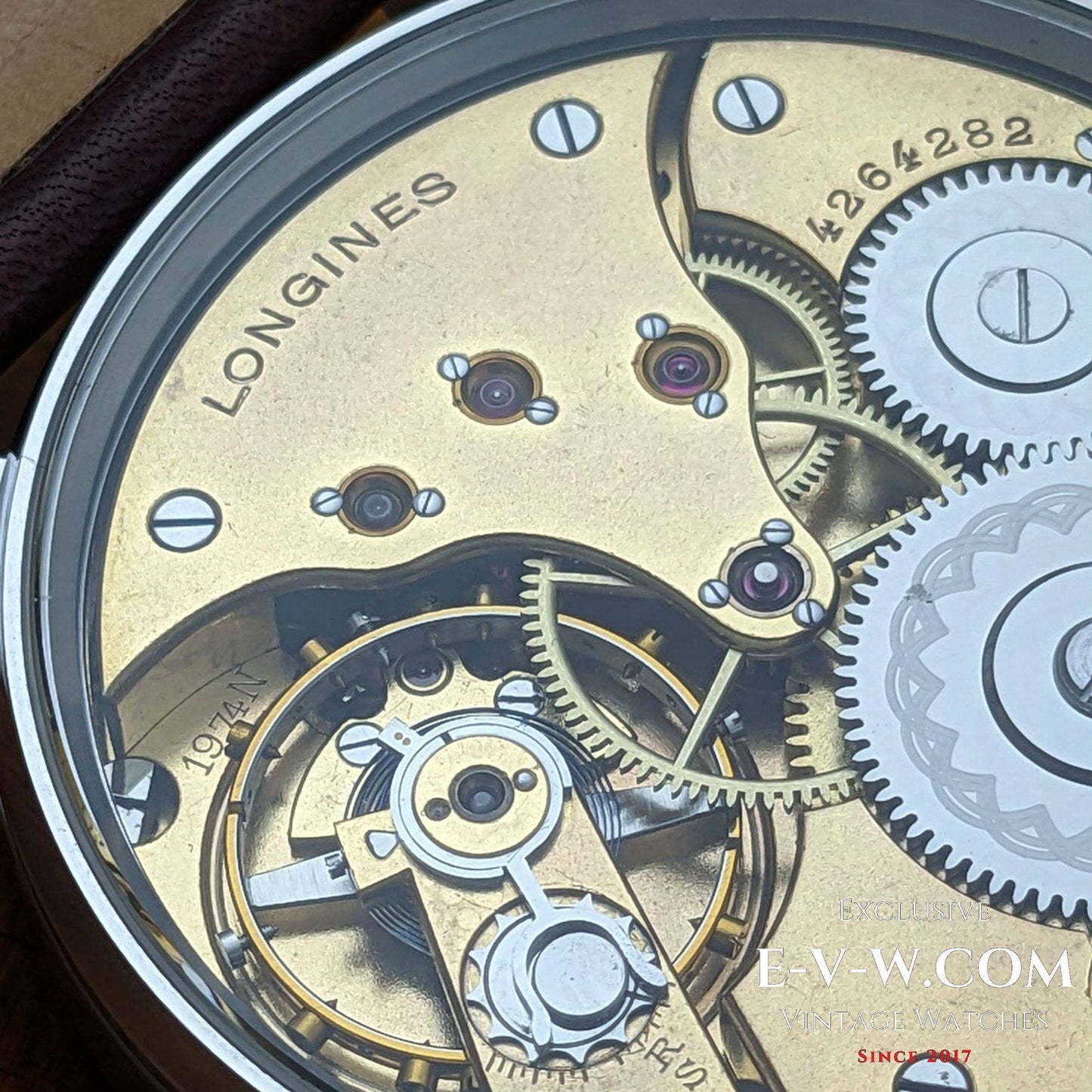 Close-up of a Longines watch mechanism with visible branding.