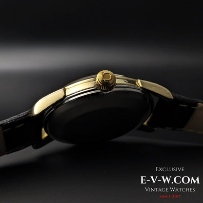 Side view of Omega Seamaster 2828-9SC Cal. 471 crown with Omega logo, highlighting gold-tone finish and slim case profile.