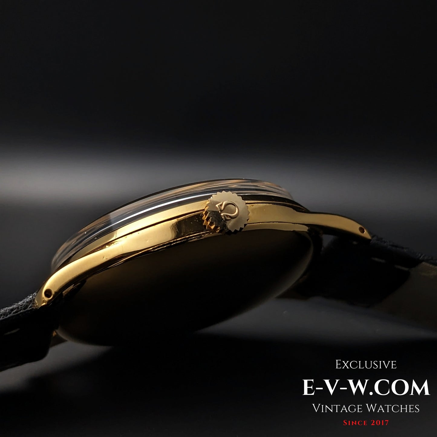 Side crown view of 1944 Vintage Omega WWII Gold Watch with gold Omega logo, highlighting fine detailing and craftsmanship.