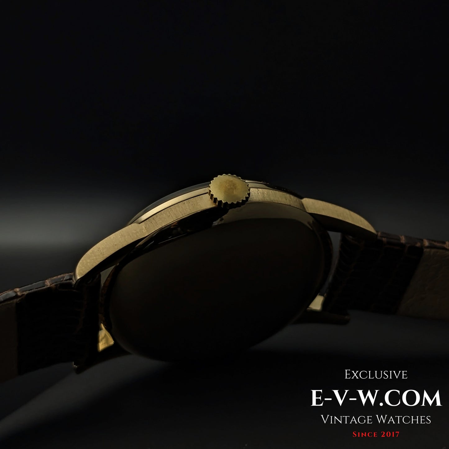 Side profile of the Vintage Omega Classic Gold Plaque watch, showcasing its gold crown, smooth case, and elegant design from 1952.