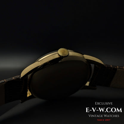 Side profile of the Vintage Omega Classic Gold Plaque watch, showcasing its gold crown, smooth case, and elegant design from 1952.