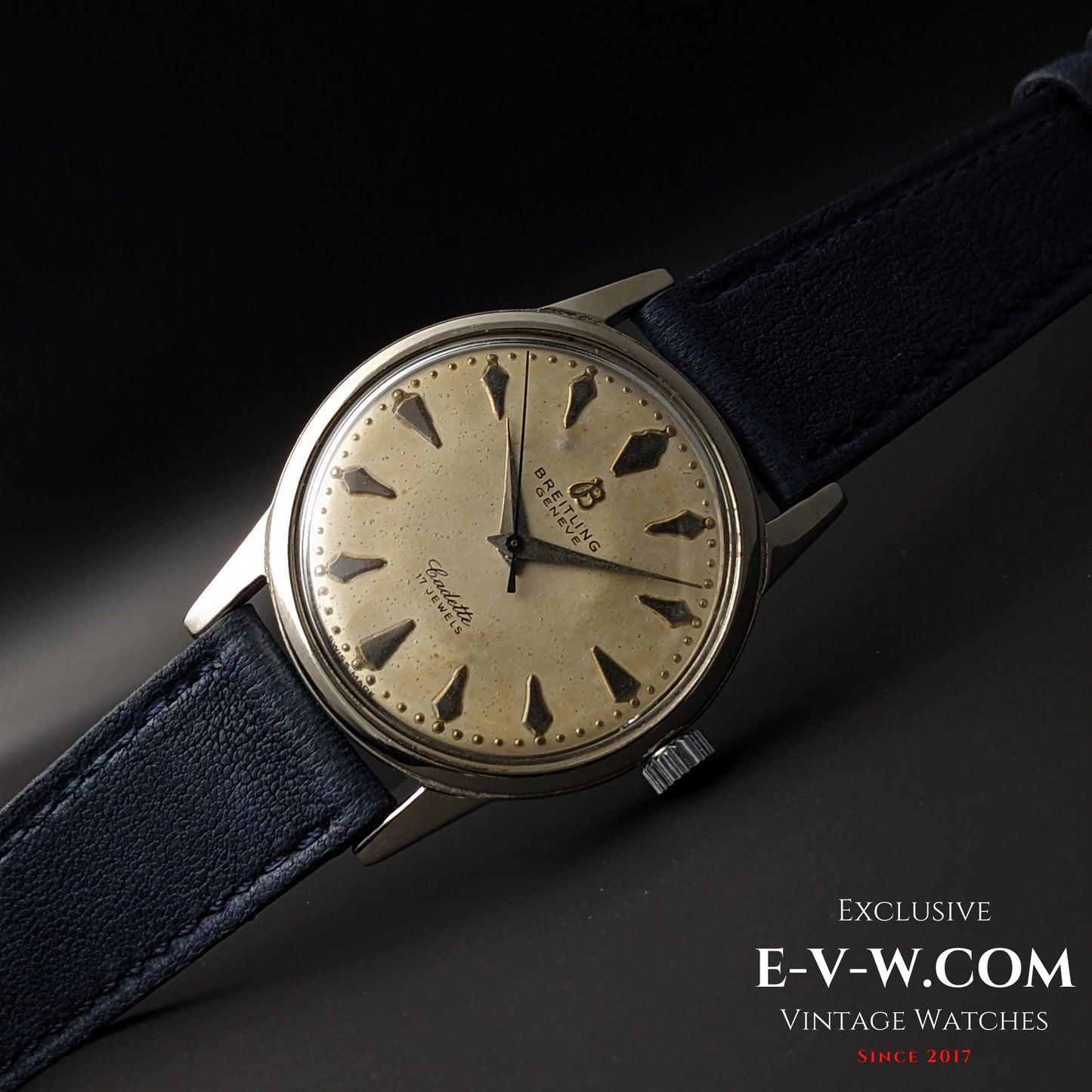 Full view of Vintage Breitling Geneve Cadette Watch 1960s laid flat, emphasizing its retro design and aged dial with triangular markers.