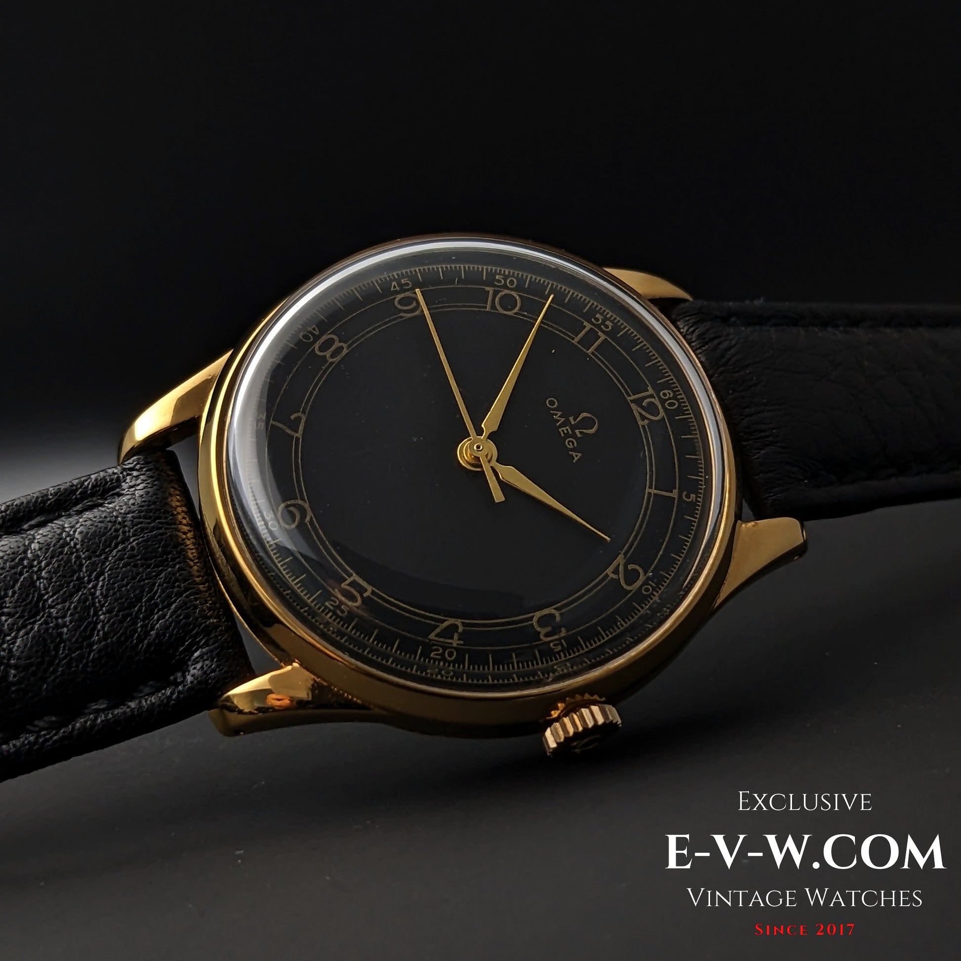 Elegant 1944 Vintage Omega WWII Gold Watch with black dial and gold-plated case, displayed on black leather strap for collectors.