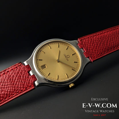 Close-up of 1957 Omega vintage watch with gold dial and red leather strap, showcasing elegant Roman numeral markers and date window.