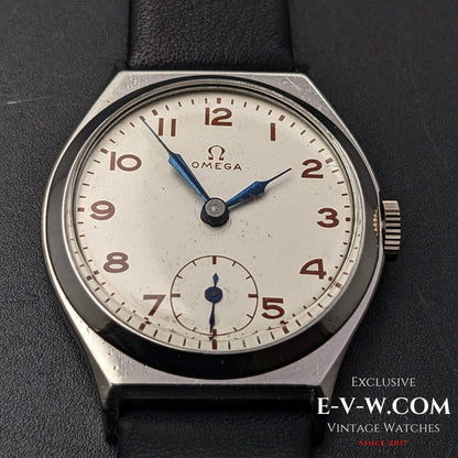 Detailed view of the Omega Art Deco wristwatch dial, highlighting the patina on the silver face, blue hands, and sub-seconds display.