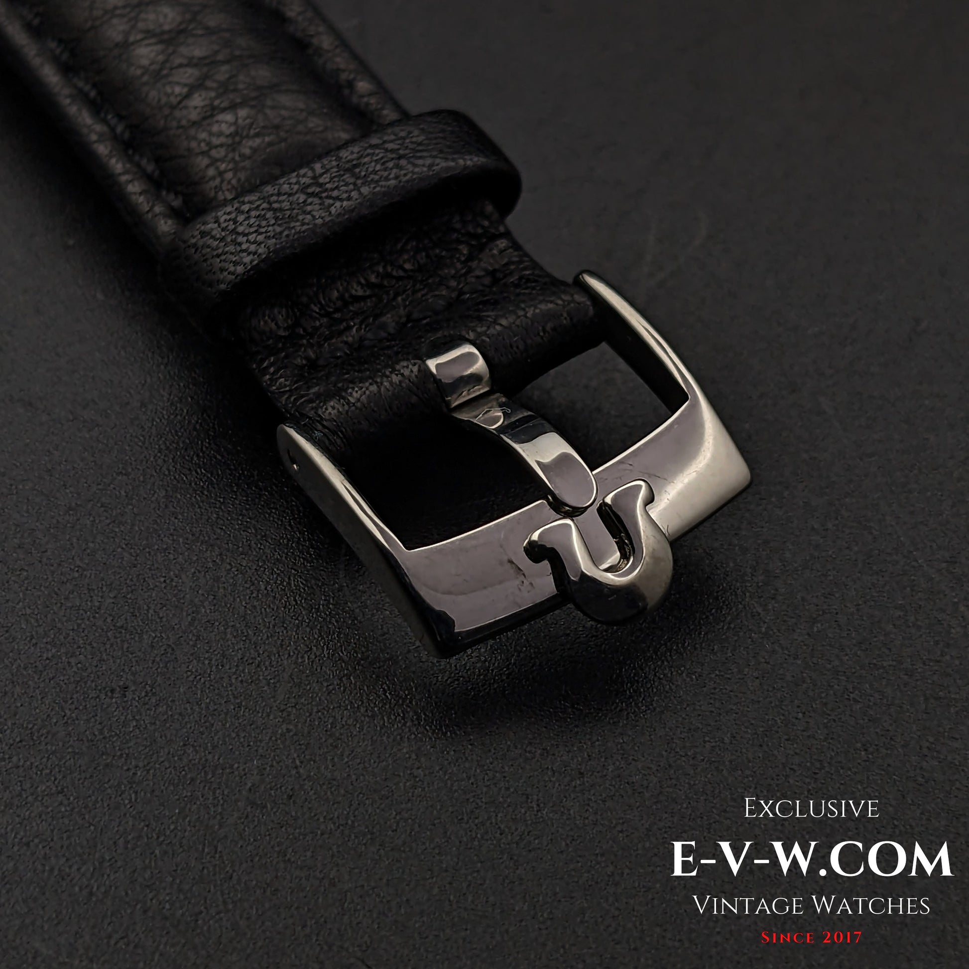 Close-up of the black leather strap and stainless steel buckle of the Omega Jumbo 38mm Ref. 2505 20, featuring a vintage Omega logo.