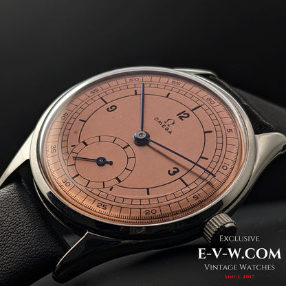 Angled close-up of Omega Vintage 1952 Jumbo Ref. 2505 wristwatch, emphasizing the salmon sector dial and blue steel hands.