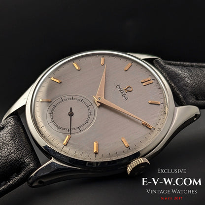 Detailed shot of Omega Jumbo 38mm Ref. 2505 20 wristwatch, showcasing its brushed silver dial, gold indices, and vintage Swiss craftsmanship.