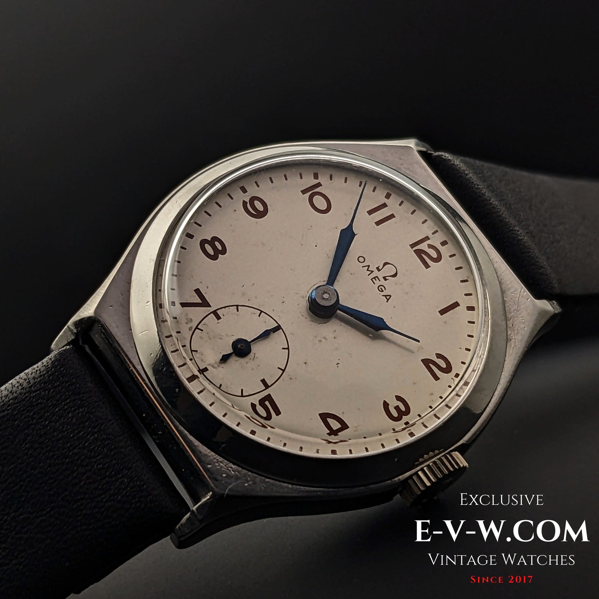 Elegant Omega wristwatch from 1935 with a silver dial, blue hands, and Arabic numerals, reflecting the timeless Art Deco design in a steel case.