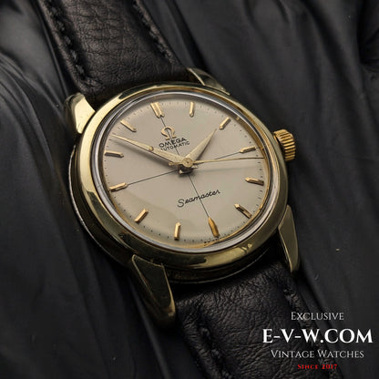 Vintage Omega Seamaster Ref. 2828-9SC Cal. 471 with gold-tone case and cream dial, resting on black leather strap and gloves.