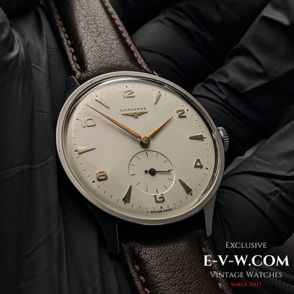 Close-up of 1955 Longines Jumbo Calatrava Ref 2849 watch with Cal. 1268Z, featuring a silver dial and gold-tone hands on brown leather strap.