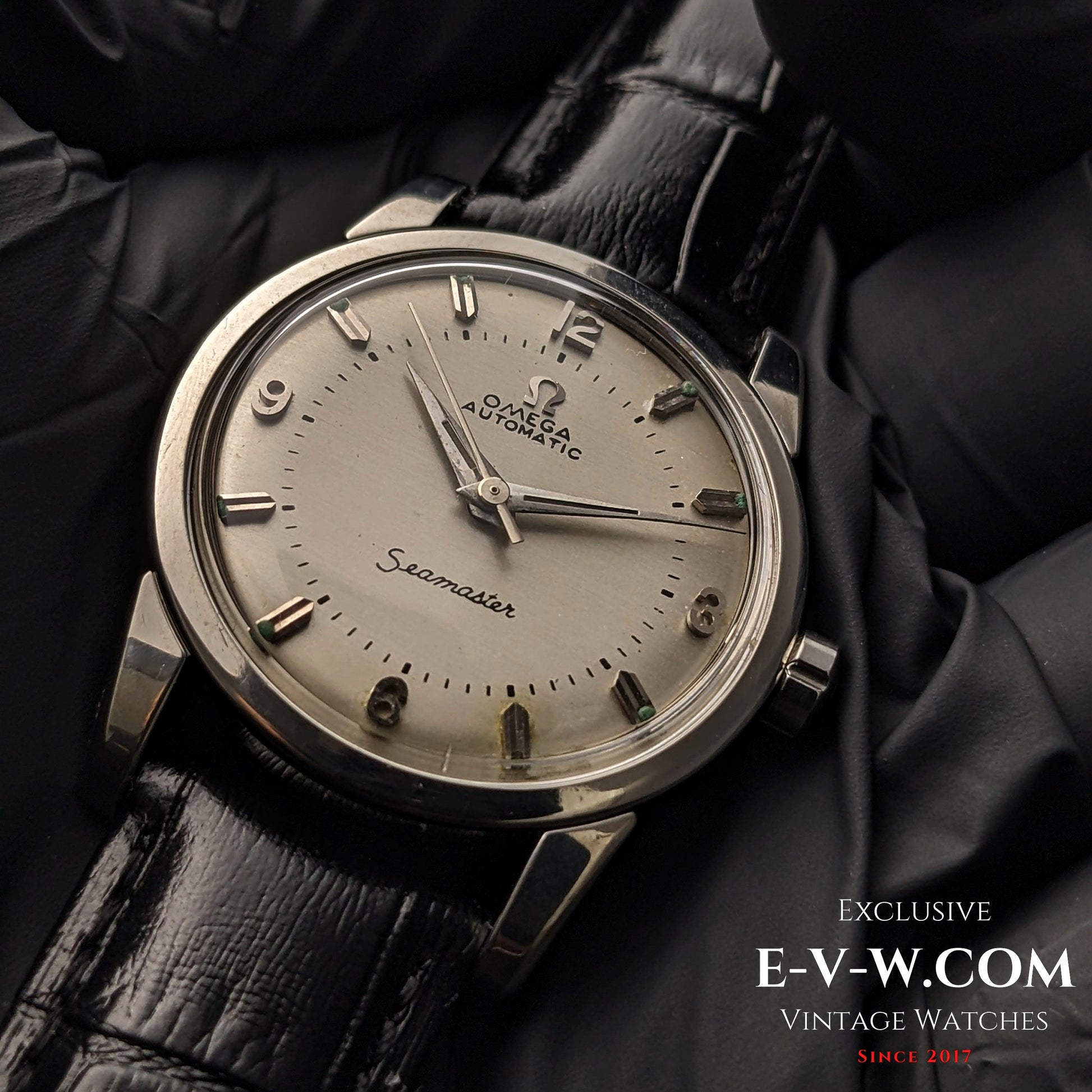 Vintage 1958 Omega Seamaster Automatic Watch with silver dial, Cal. 501 movement, and black leather strap, displayed on black gloves.