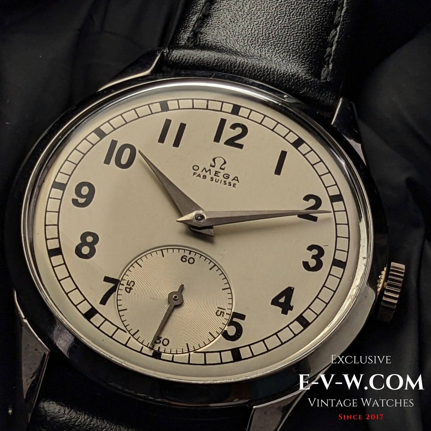 Vintage Omega FAB SUISSE Ref. 2750-6 wristwatch with a silver dial, black numerals, and a subdial at 6 o’clock. Classic 1954 timepiece with a black leather strap.