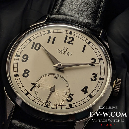 Vintage Omega FAB SUISSE Ref. 2750-6 wristwatch with a silver dial, black numerals, and a subdial at 6 o’clock. Classic 1954 timepiece with a black leather strap.