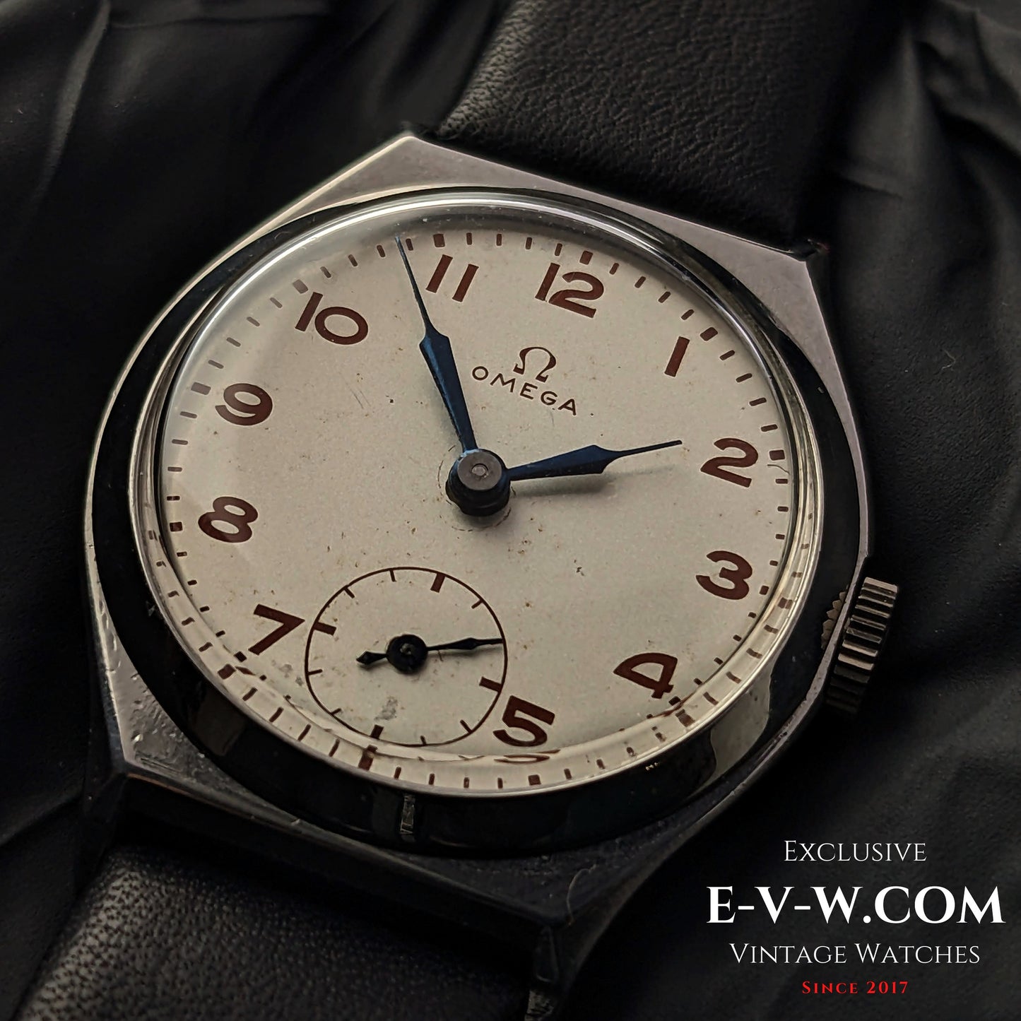 Vintage 1935 Omega Art Deco wristwatch with a silver-tone dial, blue hands, and Arabic numerals. Features Cal. 26.5SOBT2 movement in a steel case.