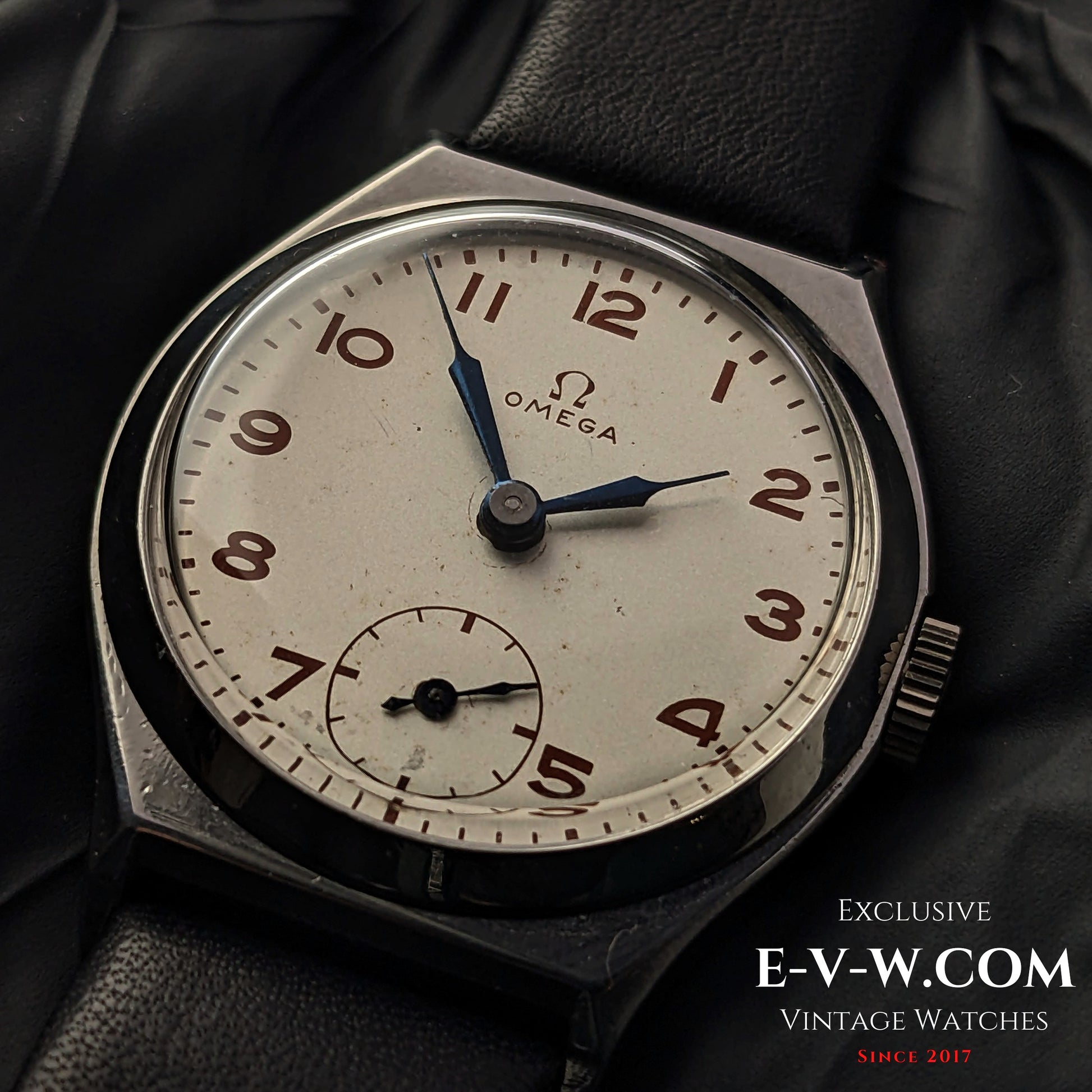 Vintage 1935 Omega Art Deco wristwatch with a silver-tone dial, blue hands, and Arabic numerals. Features Cal. 26.5SOBT2 movement in a steel case.