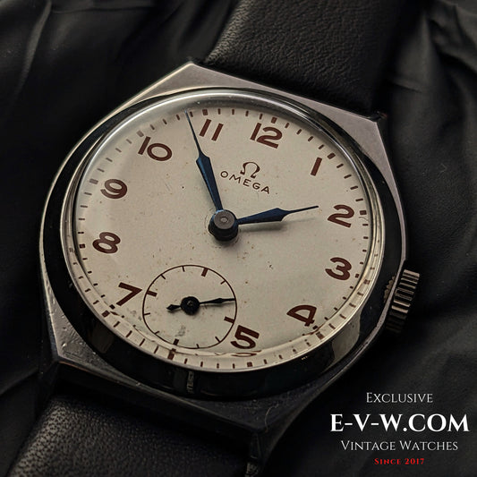 Vintage 1935 Omega Art Deco wristwatch with a silver-tone dial, blue hands, and Arabic numerals. Features Cal. 26.5SOBT2 movement in a steel case.