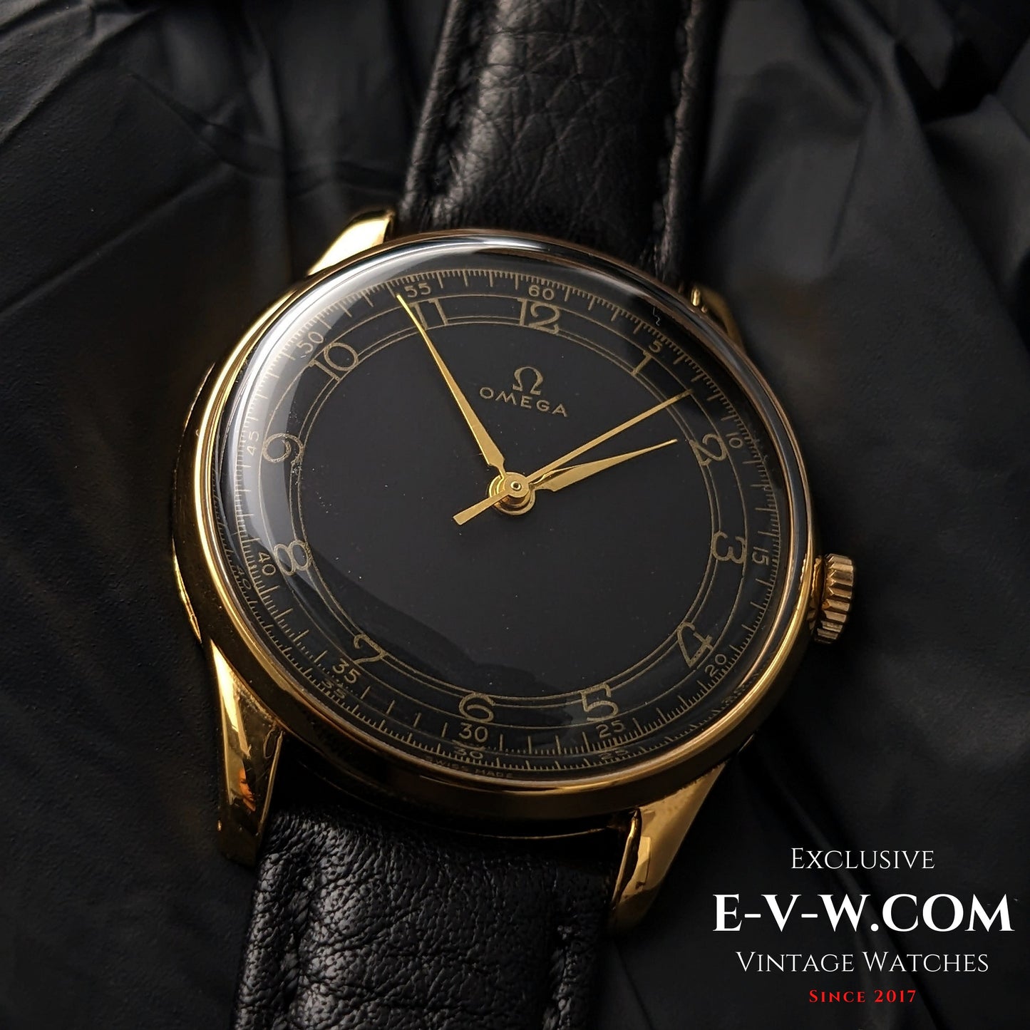 Vintage Omega WWII Gold Watch 1944 with black sector dial and gold-plated case, displayed on black leather strap for collectors.