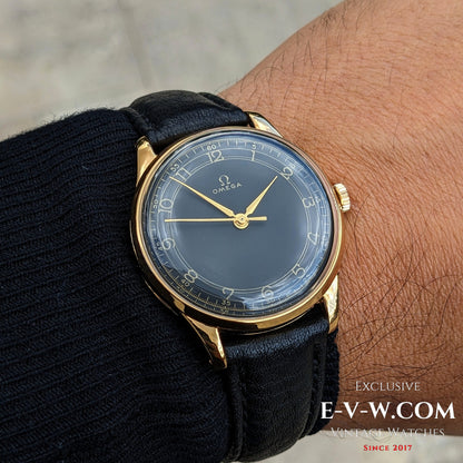 1944 Vintage Omega Gold Watch worn on wrist, showcasing elegant black dial and gold case from WWII era, ideal for vintage watch enthusiasts.