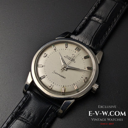 Close-up of Vintage 1958 Omega Seamaster Automatic Watch featuring a silver dial, Arabic numerals, and black leather strap.