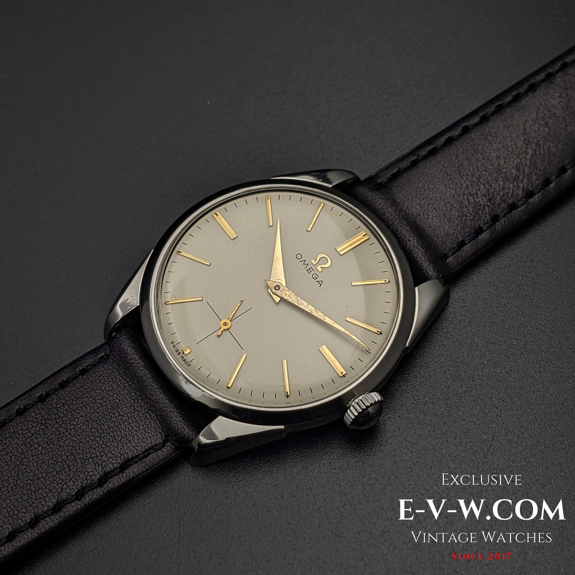 Omega CK 2900 Vintage 1956 watch with a champagne dial and gold-tone hands, paired with a black leather strap. A refined and collectible timepiece.