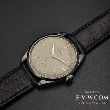 Omega CK 2900 Vintage 1956 watch with a champagne dial and gold-tone hands, paired with a black leather strap. A refined and collectible timepiece.