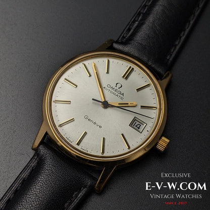 Close-up of Omega Geneve 1973 Watch Ref. 1660163 with gold-tone markers and hands on a silver dial, paired with a black leather strap.