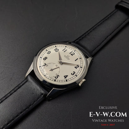 Omega FAB SUISSE Ref. 2750-6 vintage wristwatch with a silver dial and black leather strap. A 1954 classic with a subdial at 6 o’clock.