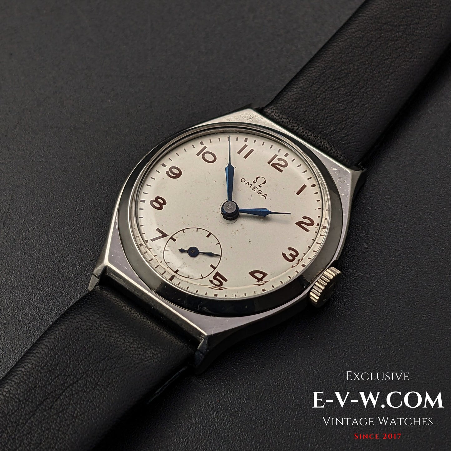 Classic Omega Art Deco wristwatch from 1935 with a silver dial, blue hands, and a black leather strap, featuring Cal. 26.5SOBT2 movement.