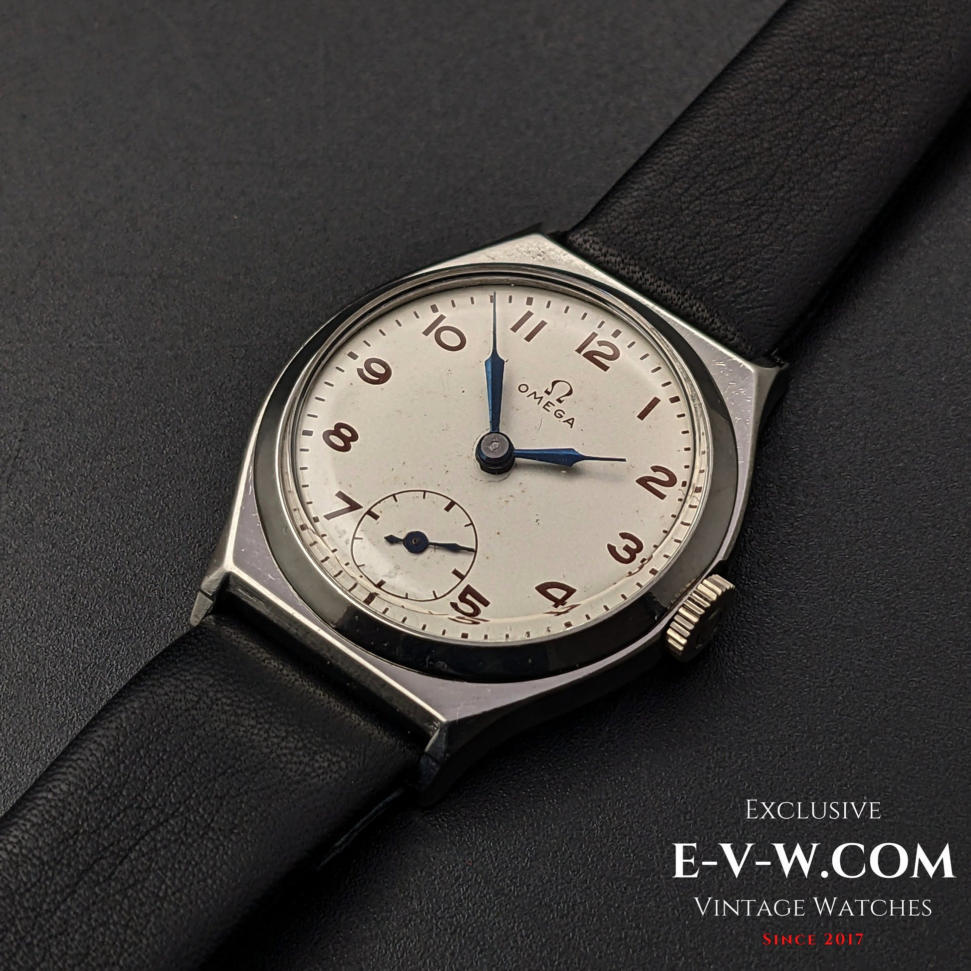 Classic Omega Art Deco wristwatch from 1935 with a silver dial, blue hands, and a black leather strap, featuring Cal. 26.5SOBT2 movement.