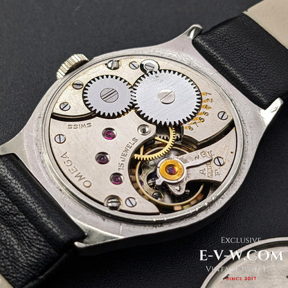 Close-up of the Omega Cal. 26.5SOBT2 movement, revealing intricate gears and 15-jewel mechanism inside the vintage 1935 steel wristwatch.