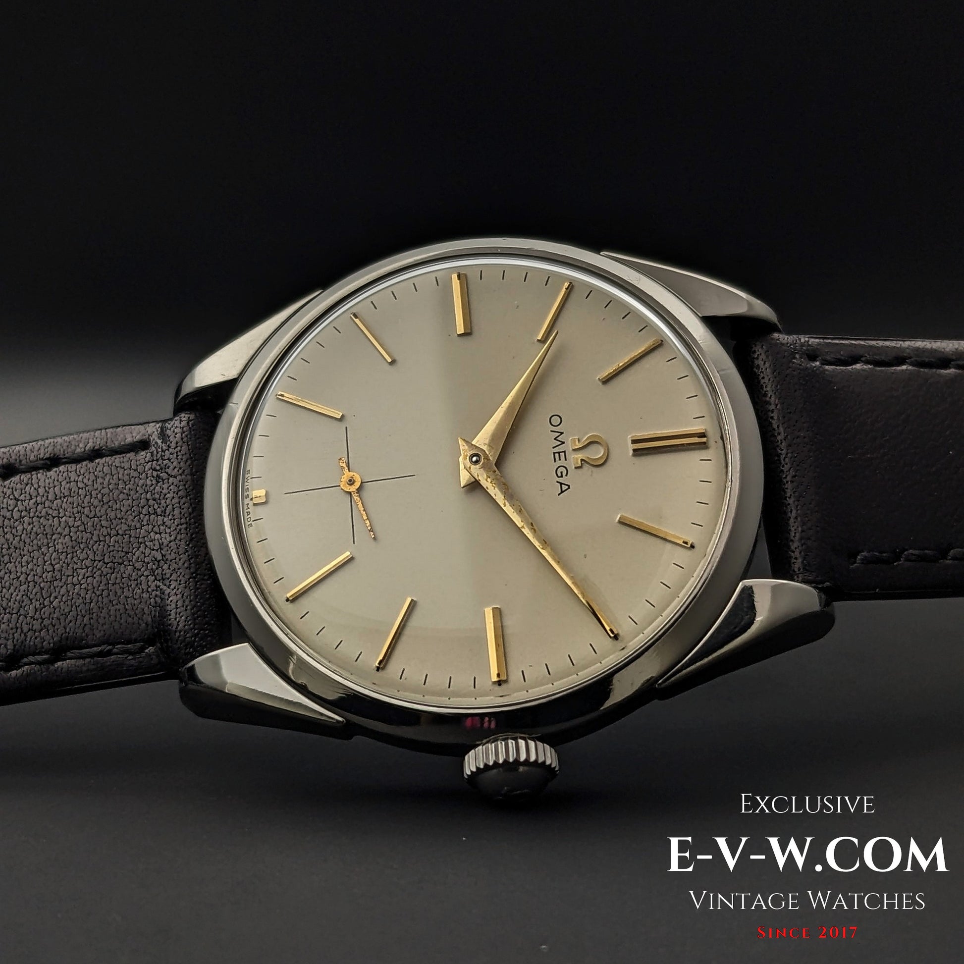 Side view of Omega CK 2900 Vintage 1956 watch, highlighting its sleek stainless steel case and domed crystal. A rare and elegant vintage piece.