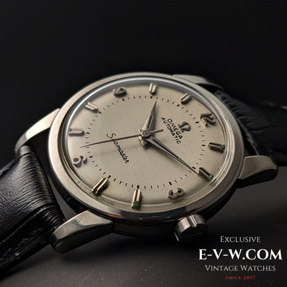 Angled view of Vintage 1958 Omega Seamaster Automatic Watch with domed crystal and silver-tone case on black leather strap.