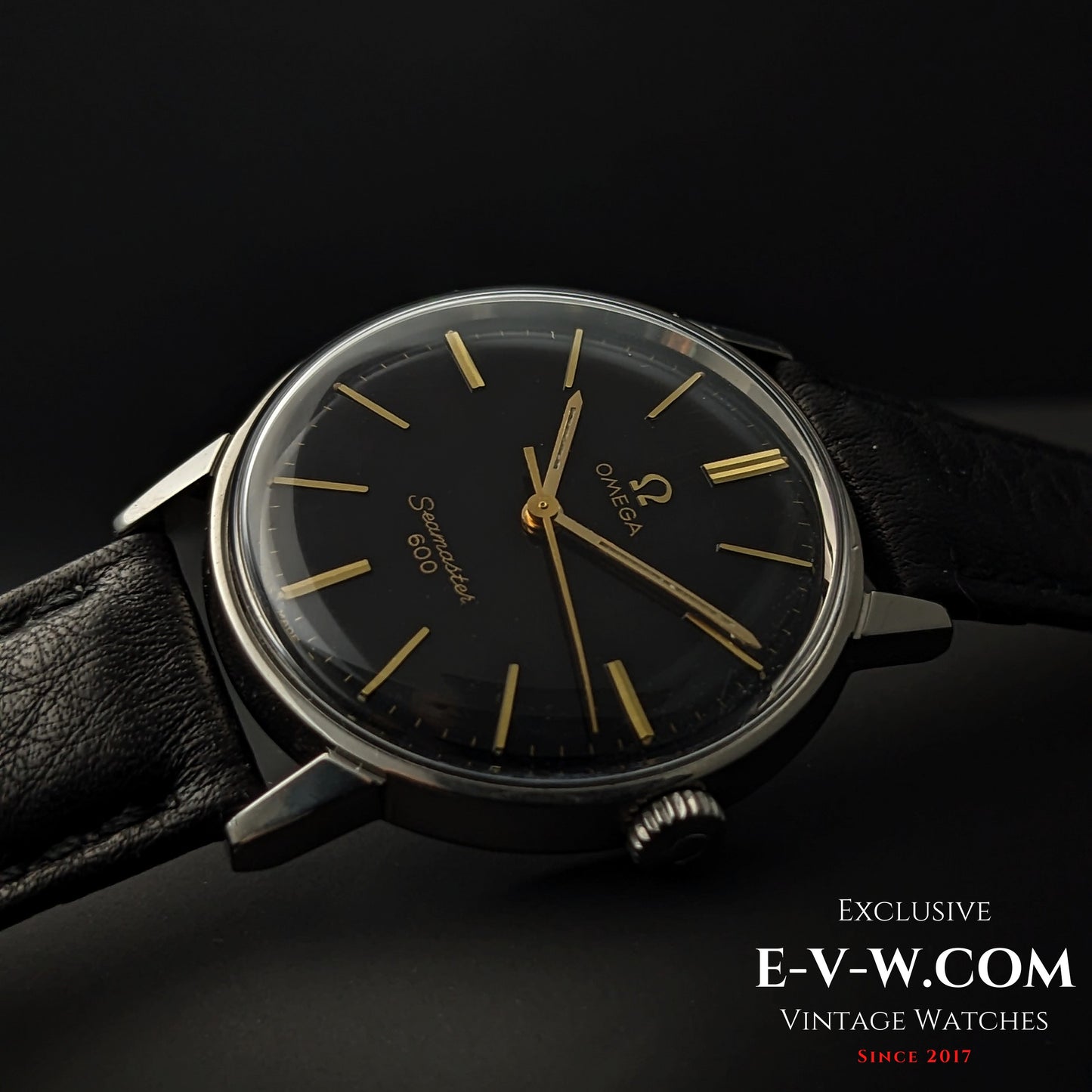 Side angle of Omega Seamaster 600 1966 Ref. 135011 with domed crystal and black dial, emphasizing vintage design and gold-tone details.