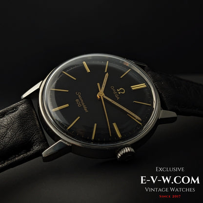 Side angle of Omega Seamaster 600 1966 Ref. 135011 with domed crystal and black dial, emphasizing vintage design and gold-tone details.