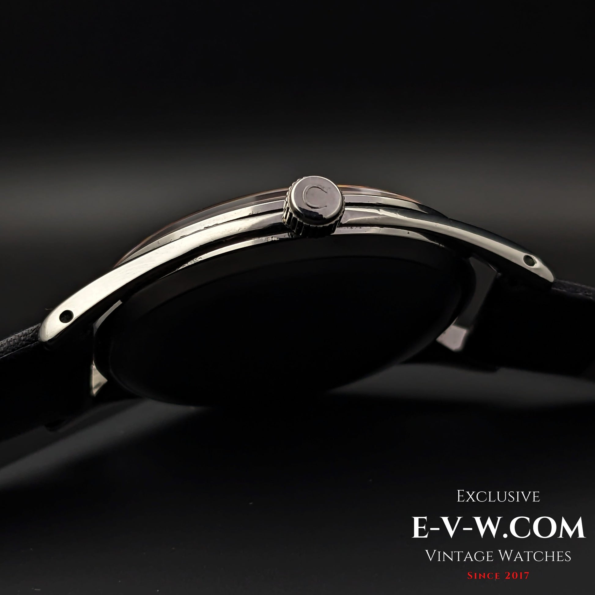 Side profile of Omega Vintage 1952 Jumbo Ref. 2505 wristwatch, showcasing the polished steel case and signed crown.