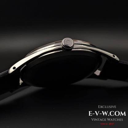 Side profile of Omega Vintage 1952 Jumbo Ref. 2505 wristwatch, showcasing the polished steel case and signed crown.