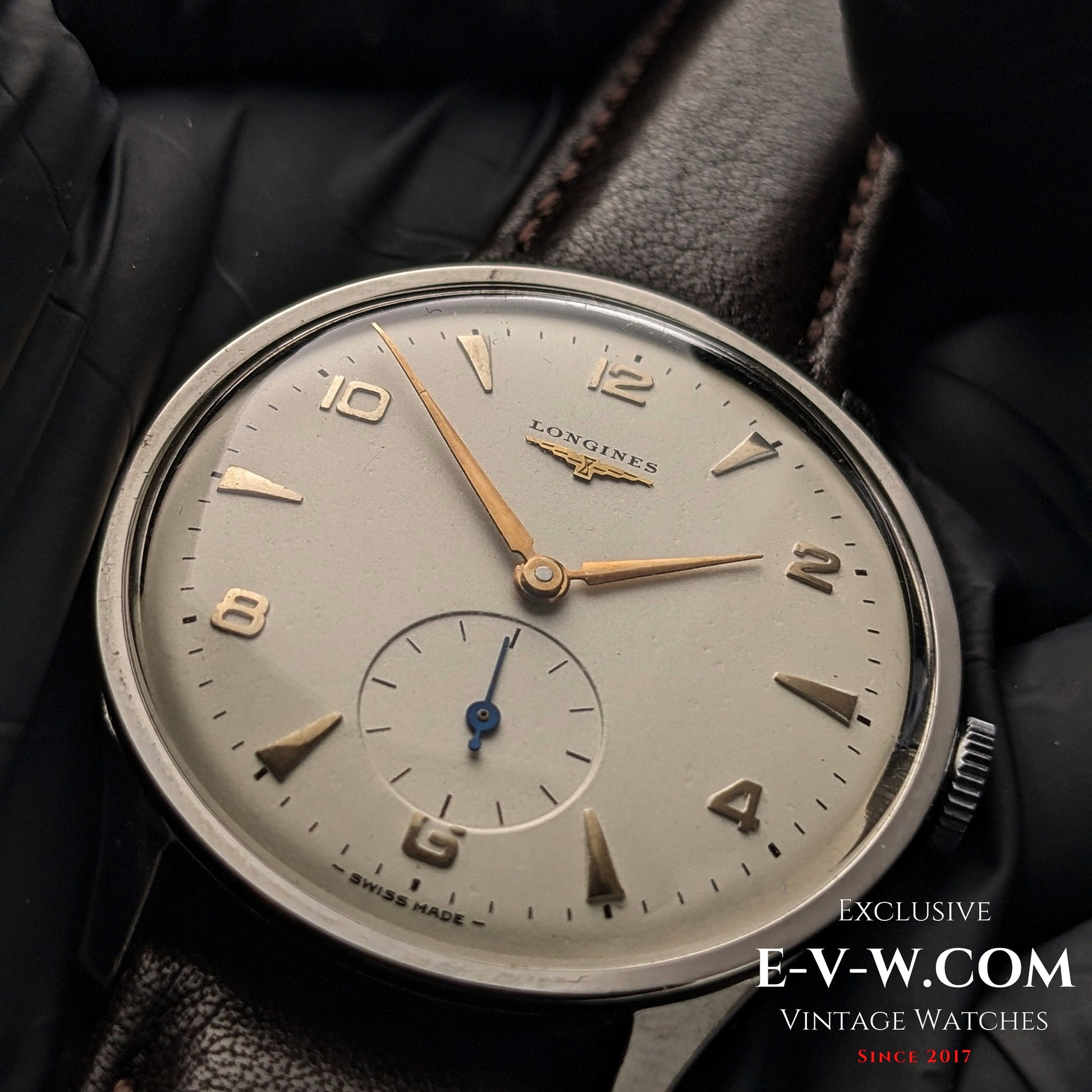 Macro shot of 1955 Longines Jumbo Calatrava Ref 2849 dial, highlighting gold-tone hands, Arabic numerals, and sub-seconds register.