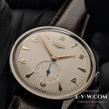 Macro shot of 1955 Longines Jumbo Calatrava Ref 2849 dial, highlighting gold-tone hands, Arabic numerals, and sub-seconds register.