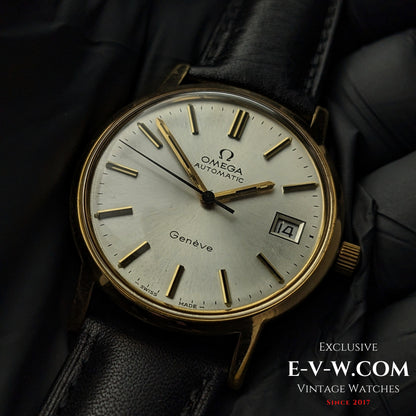 Omega Geneve 1973 Watch Ref. 1660163 with gold case and silver dial, displayed on black cushion for luxury presentation.